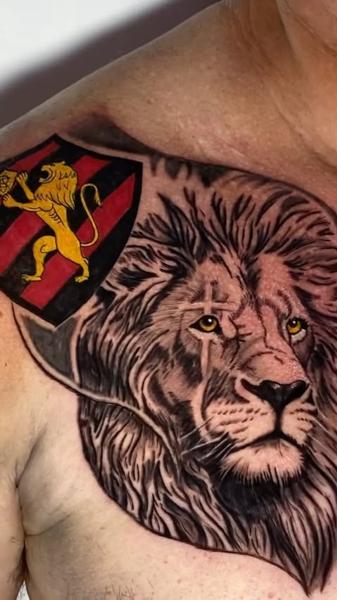 Realism lion and shield tattoo by @nettovasconcelostattoo
