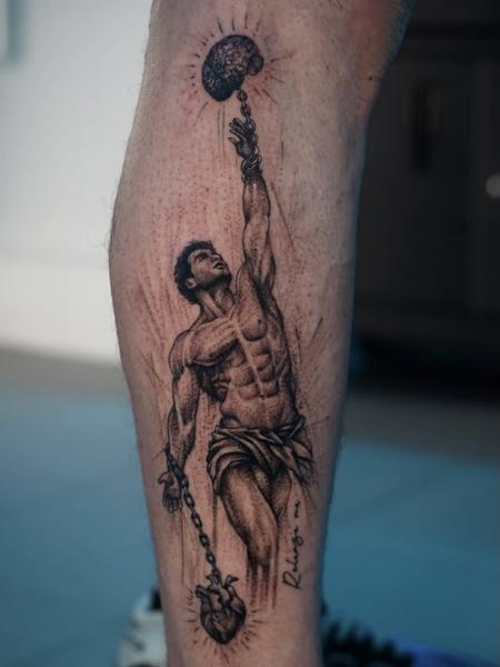 Realism man with brain and heart tattoo by @nikoselmaidis_tattoo