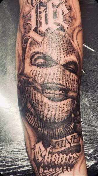 Realism masked figure tattoo by @nikosrodis