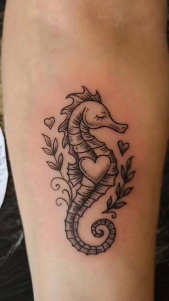 Illustrative seahorse with hearts tattoo by @oleg_narvski