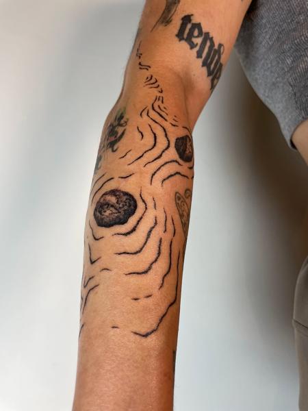 Fine line topographic lines tattoo by @tattoli__