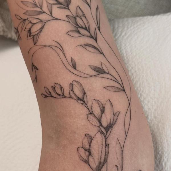 Fine line dotwork floral branch tattoo by @tattoopaiges