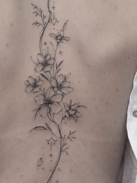 Fine line floral vine tattoo by @tattoopaiges