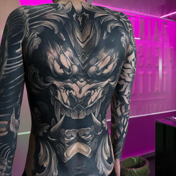 Blackwork demonic face tattoo by @pain4pleasure.tattoo
