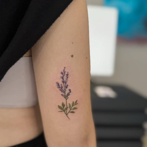 Fine line lavender sprig tattoo by @kristeake.tattoo