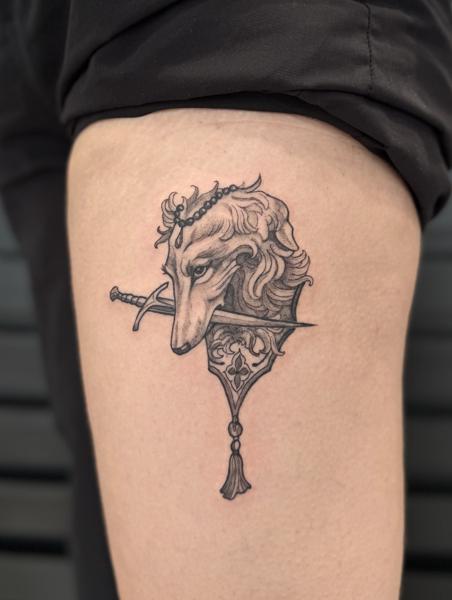 Blackwork wolf dagger tattoo by @kristeake.tattoo