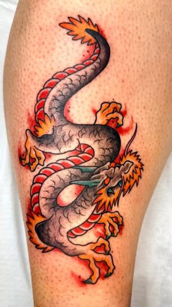 Traditional traditional dragon tattoo by @panikas_tattooer