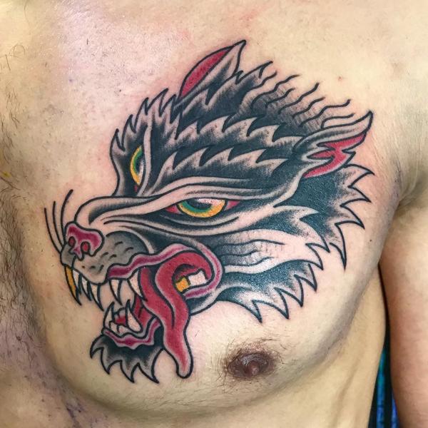 Traditional wolf head tattoo by @ksr_junx