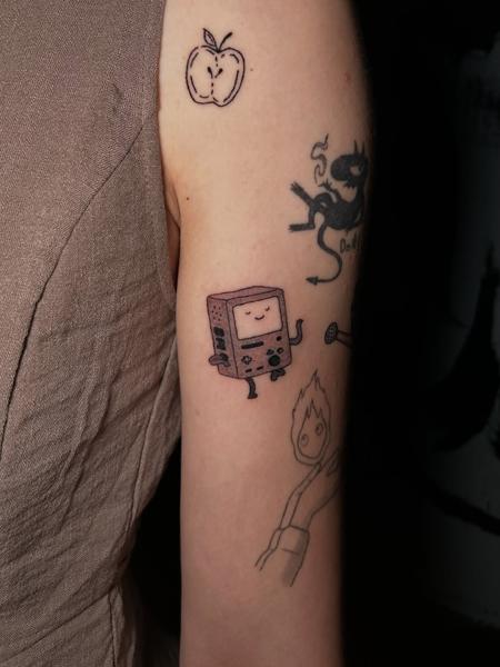 Fine line cartoon character tattoo by @littletinypoke