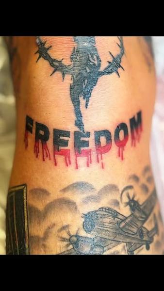 Illustrative dripping freedom text tattoo by @mrdbtattoo