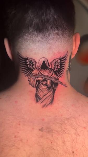 Realism angel with gun tattoo by @kulo_tattoo_art