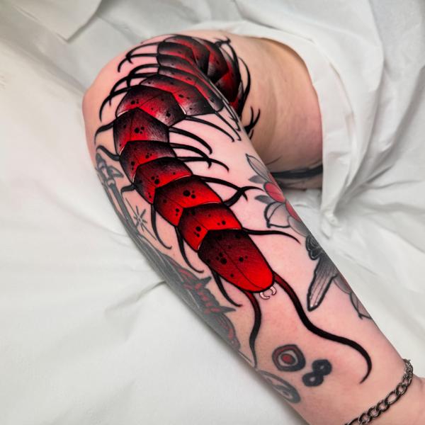 Traditional red centipede tattoo by @petermurrayartist