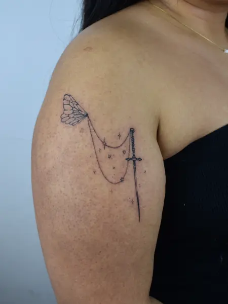 Fine line sword and wing tattoo by @artbymateospi