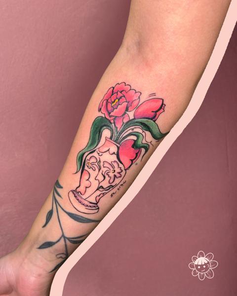 Traditional floral vase tattoo by @buggietattoostudio