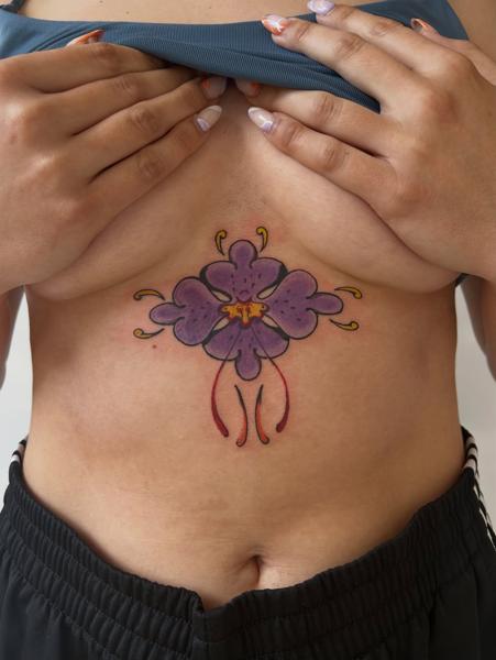 Traditional purple flower tattoo by @buggietattoostudio