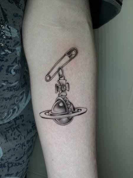 Realism saturn charm tattoo by @polishpollytattoo