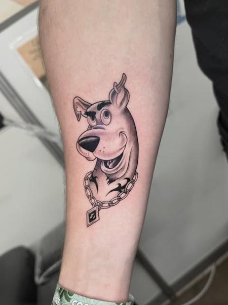 Illustrative cartoon dog tattoo by @polishpollytattoo