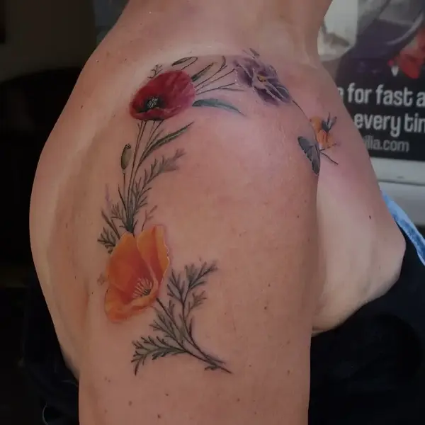 Realism floral arrangement tattoo by @purplerosebristol