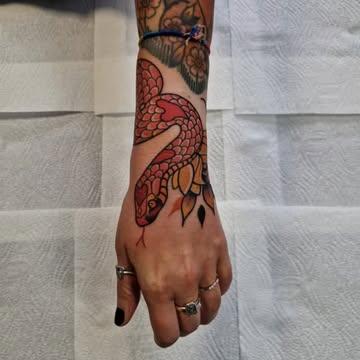 Traditional snake and leaves tattoo by @rabtattoo