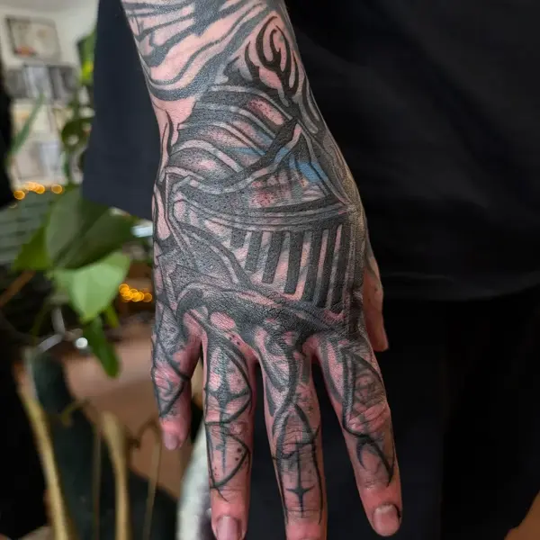 Blackwork knight helmet tattoo by @inkleigh.tattoo