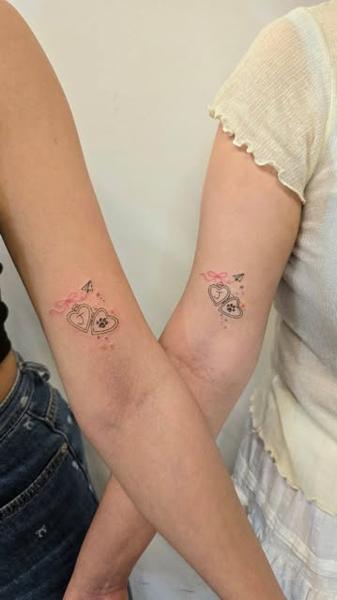 Fine line locket paw print tattoo by @tattooist_rimi