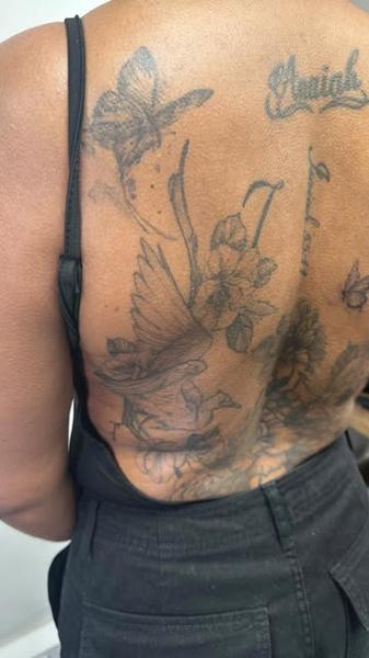 Fine line floral bird tattoo by @noka.tattoo