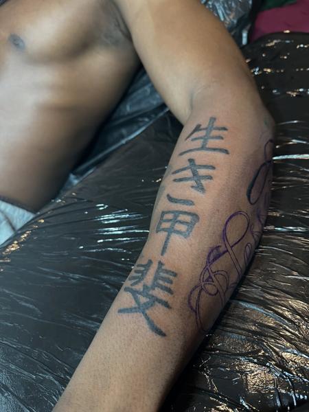 Blackwork kanji script tattoo by @noka.tattoo