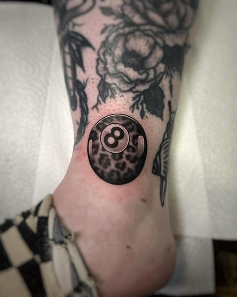 Blackwork leopard print eight ball tattoo by @rosiemalonetattoos