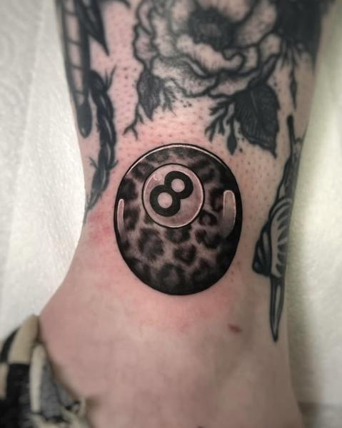 Realism magic 8 ball tattoo by @rosiemalonetattoos