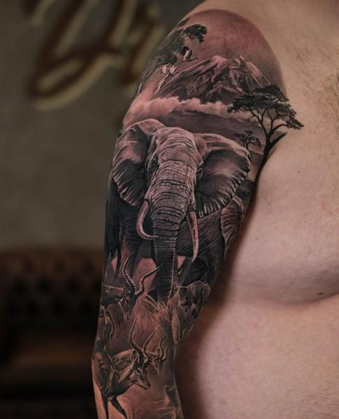 Realism elephant landscape tattoo by @rubentattooer