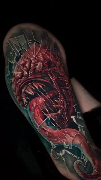 Realism monster breaking glass tattoo by @sambarbertattoo