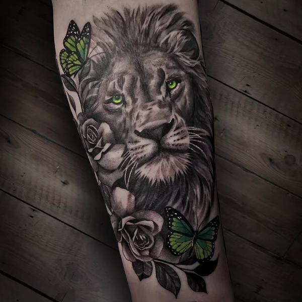 Realism black and grey with color accents lion roses butterflies tattoo by @startattooist