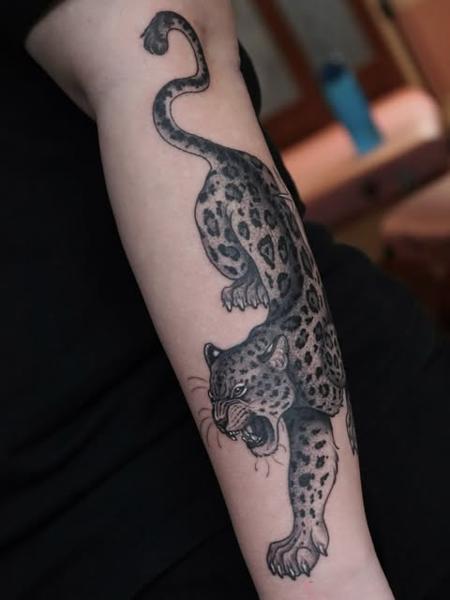 Traditional leopard tattoo by @sammylou_tattoo