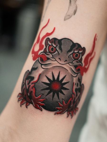 Neo-traditional flaming frog tattoo by @sasha.tattooist