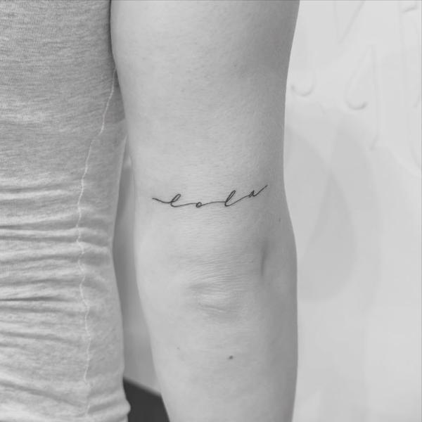 Fine line script name tattoo by @sasha7tattoos