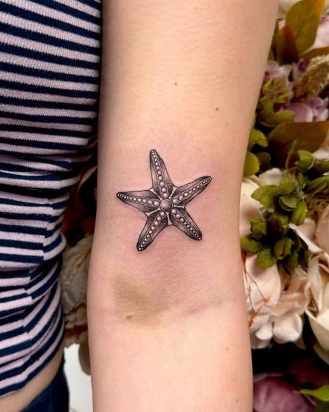 Realism starfish tattoo by @miss.saskiatattoo
