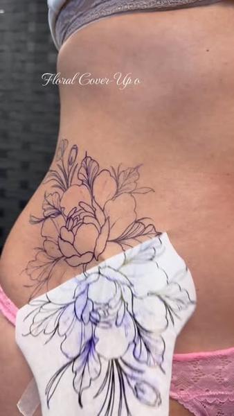 Fine line floral cover-up tattoo by @miss.saskiatattoo