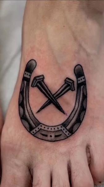 Traditional horseshoe and nails tattoo by @scott_weatherwax