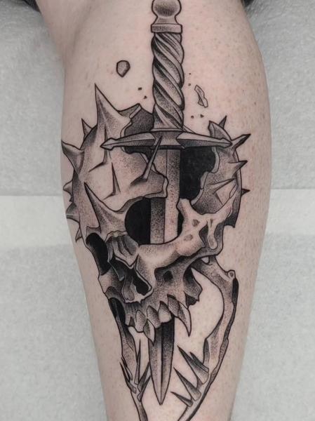 Blackwork spiked skull sword tattoo by @sean.dwyer.tattoo