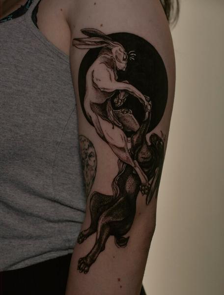Illustrative fighting hares tattoo by @sem_tattooer