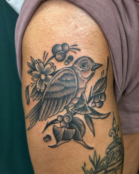 Traditional bird and flowers tattoo by @seshi.ink