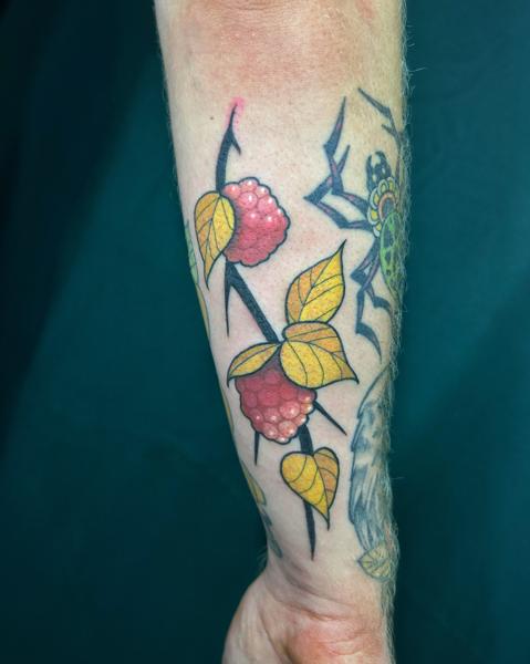 Traditional raspberry branch tattoo by @seshi.ink
