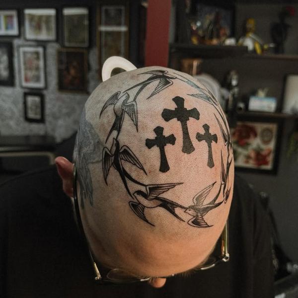 Traditional swallows and crosses tattoo by @sharitattoos