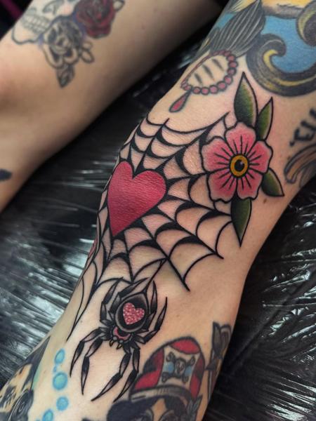 Traditional spiderweb heart flower tattoo by @sharitattoos
