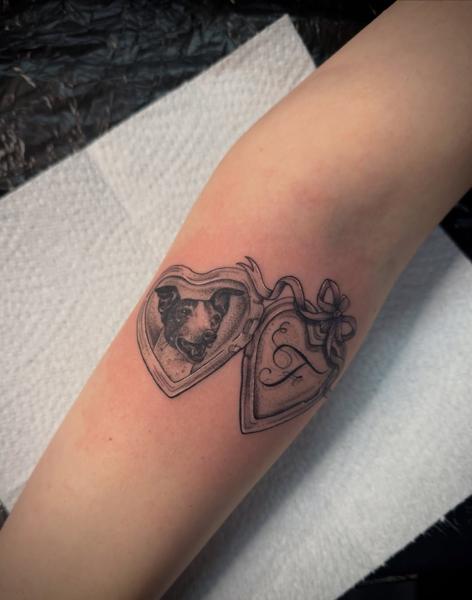 Realism dog locket tattoo by @sharneeoliver_tattoo