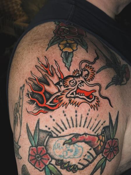Traditional flaming dragon head tattoo by @siggytattoo