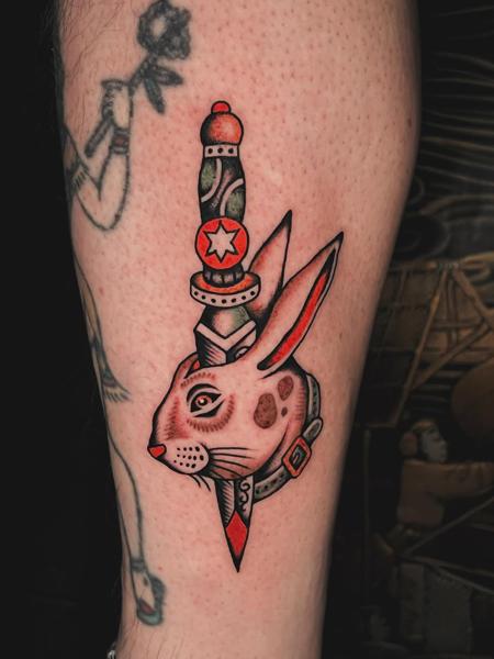 Traditional rabbit dagger tattoo by @siggytattoo