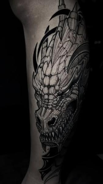 Illustrative dragon head tattoo by @slimmoxmooreblackwork
