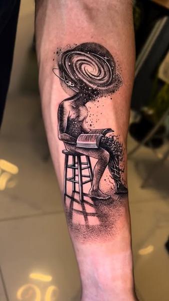 Illustrative blackwork cosmic reader tattoo by @slimmoxmooreblackwork