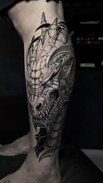 Illustrative dragon head tattoo by @slimmoxmooreblackwork